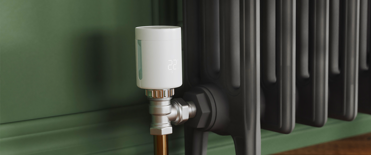 Heatmiser.com Header IMI Heatmiser neoFlo Smart Radiator thermostat on a victorian style radiator installed in a green room.